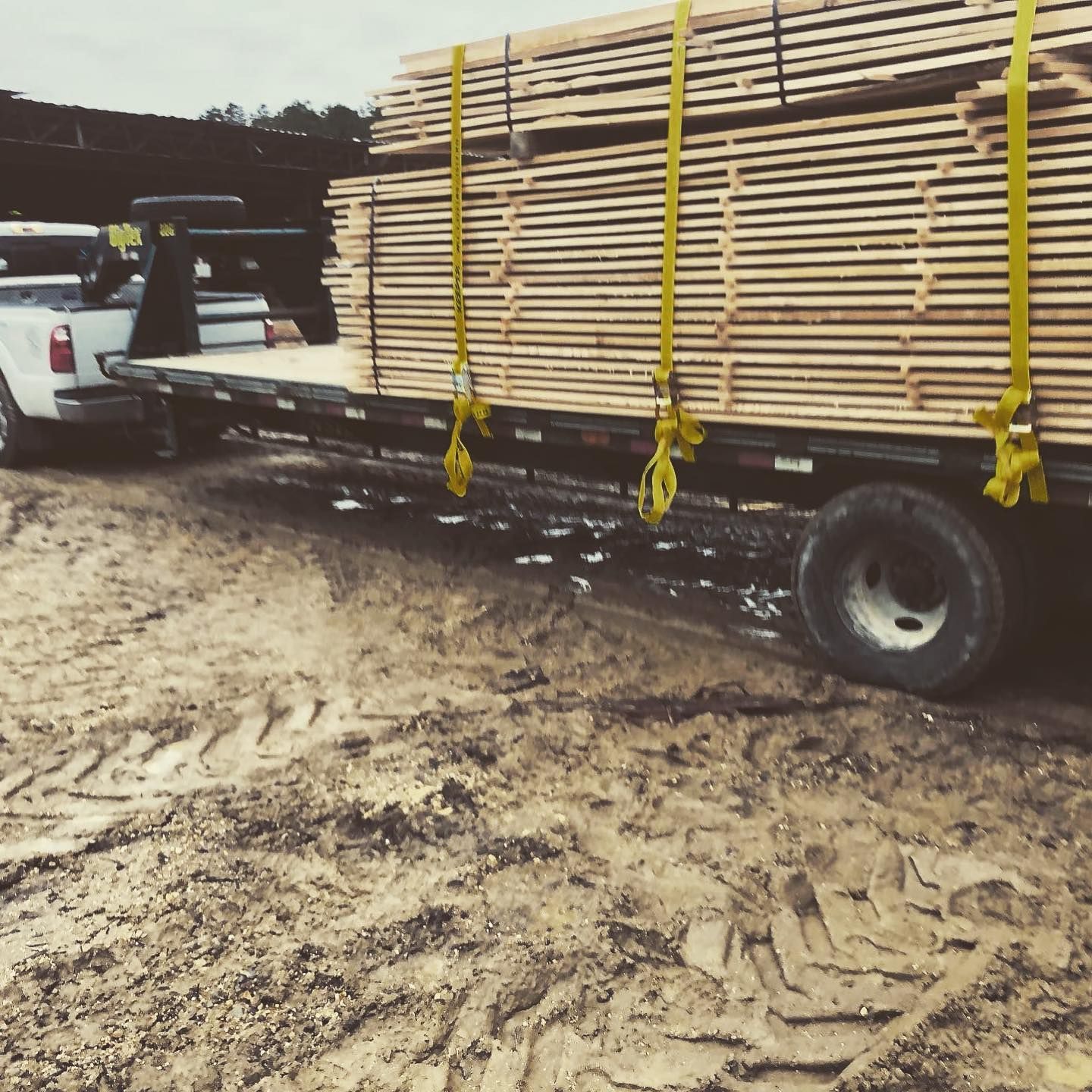 A truck is carrying a large stack of wood
