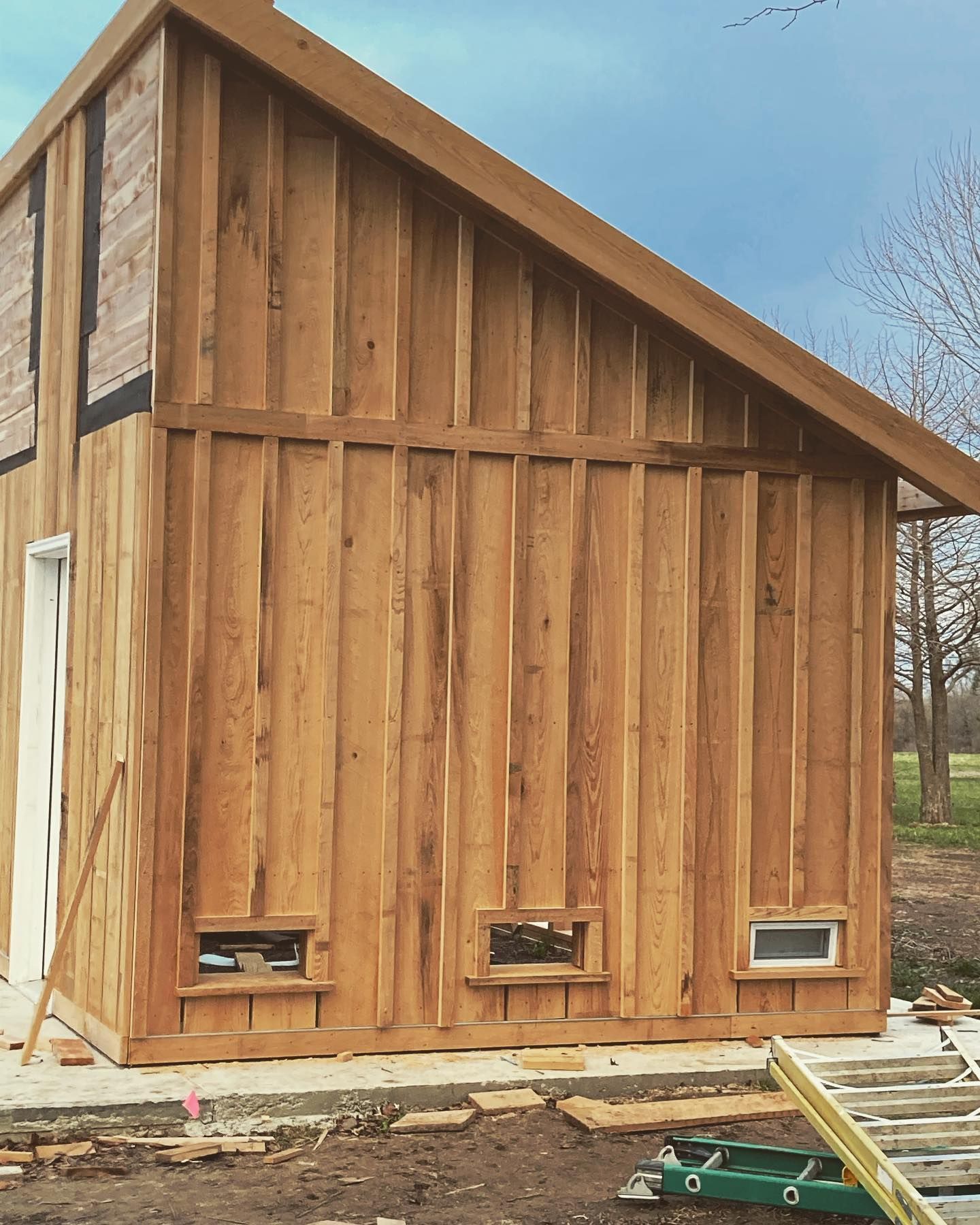 A wooden building with a ladder in front of it