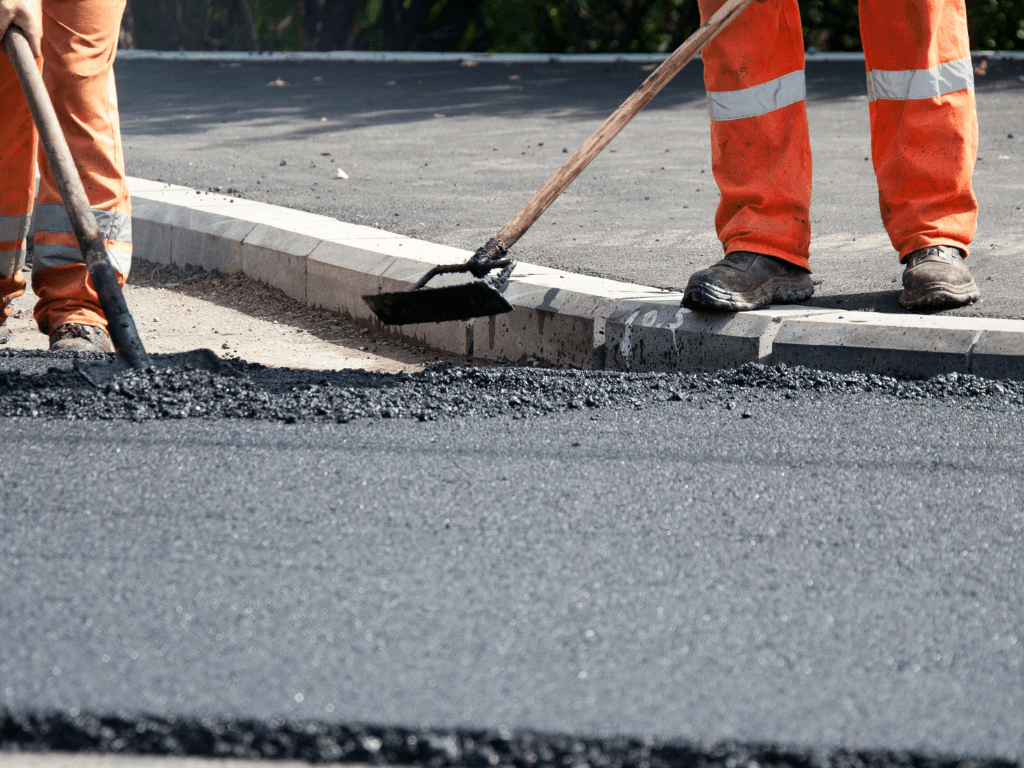 contractors installing asphalt driveway