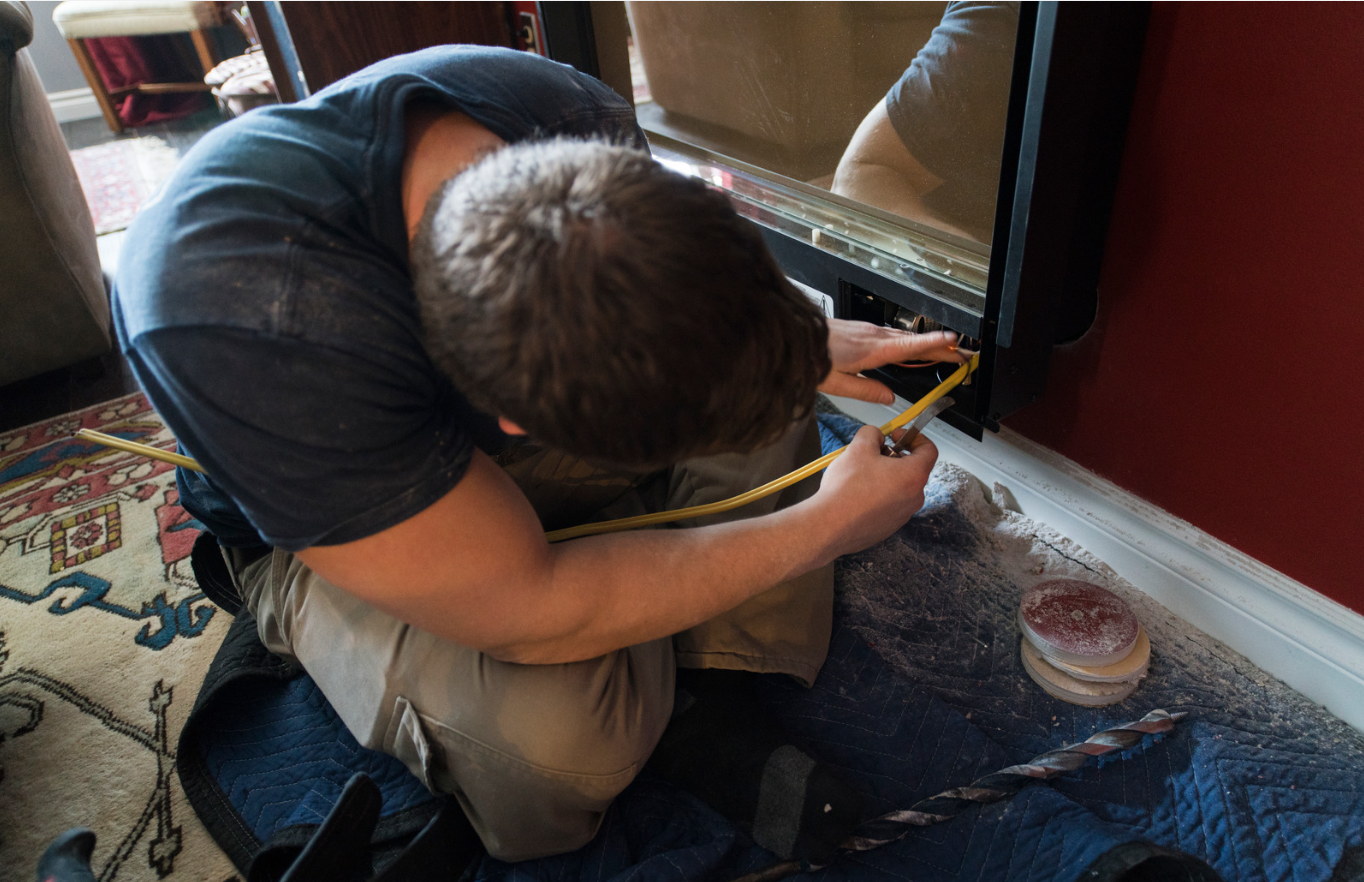 Fireplace Technician Installing Fireplace Unit