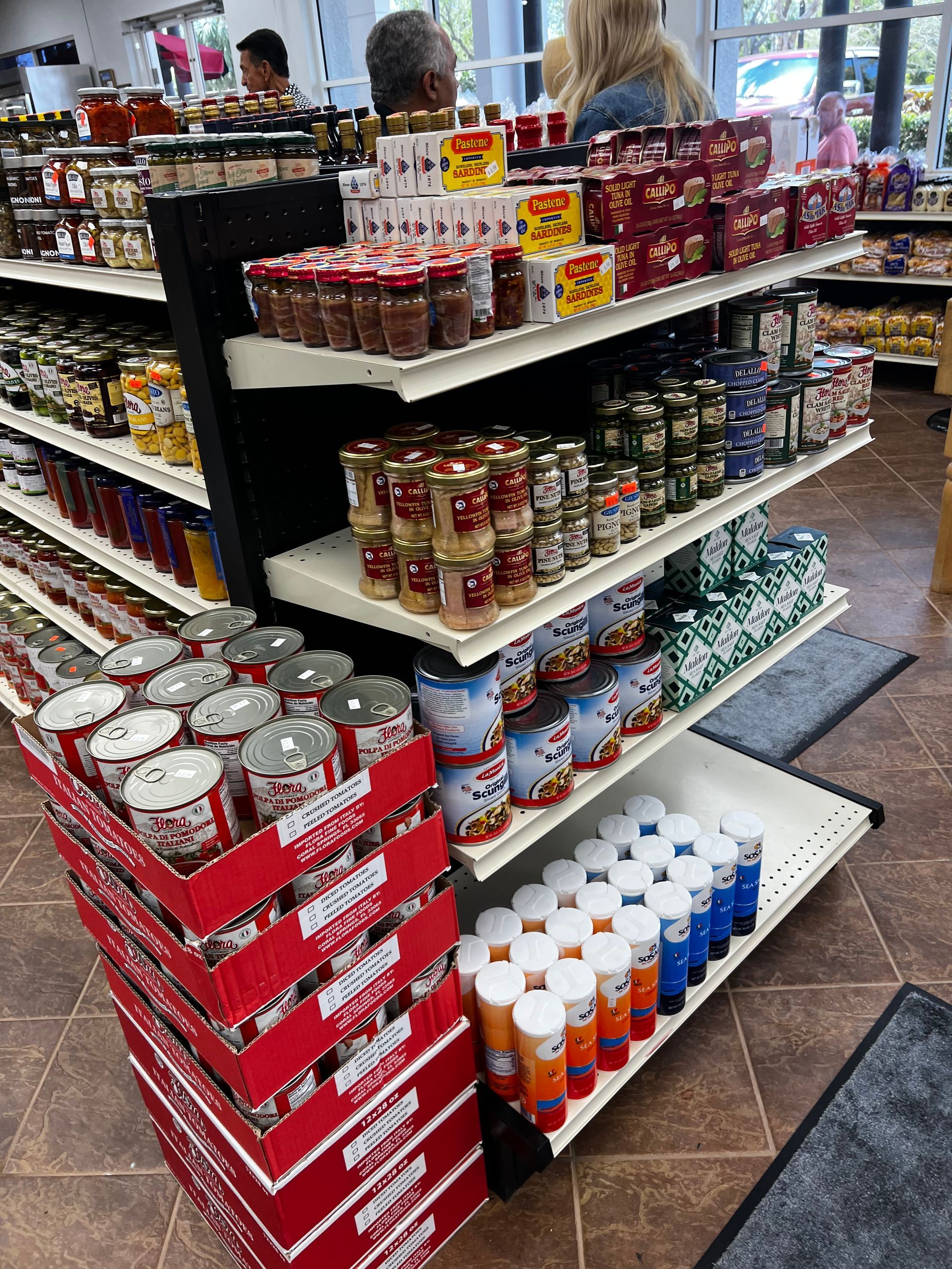 A grocery store aisle filled with lots of cans and jars.