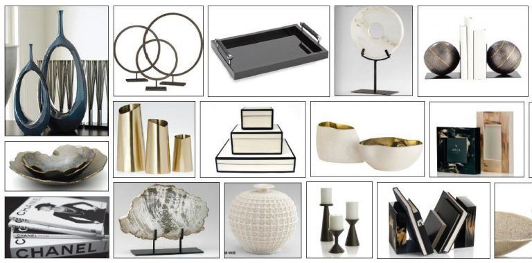 Collection of home decor items, including vases, sculptures, and books, arranged on a white surface.
