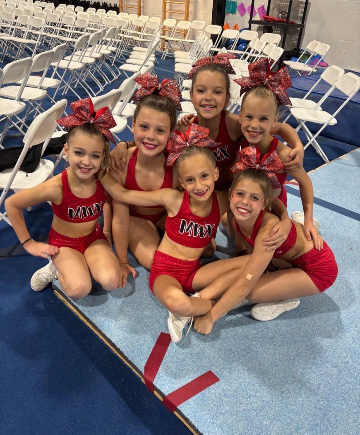 A group of cheerleaders are posing for a picture together