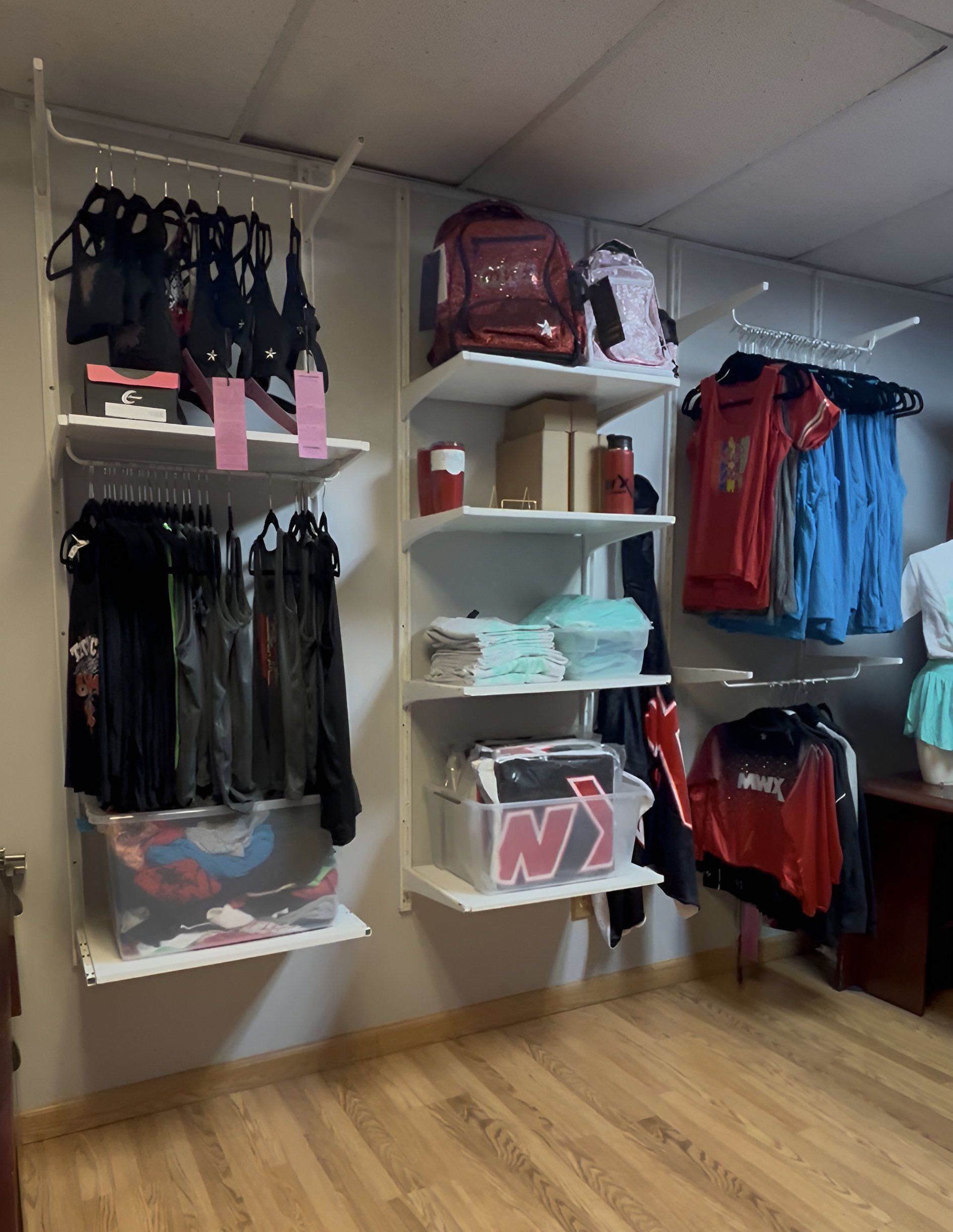 A closet filled with clothes and a box that says ny on it