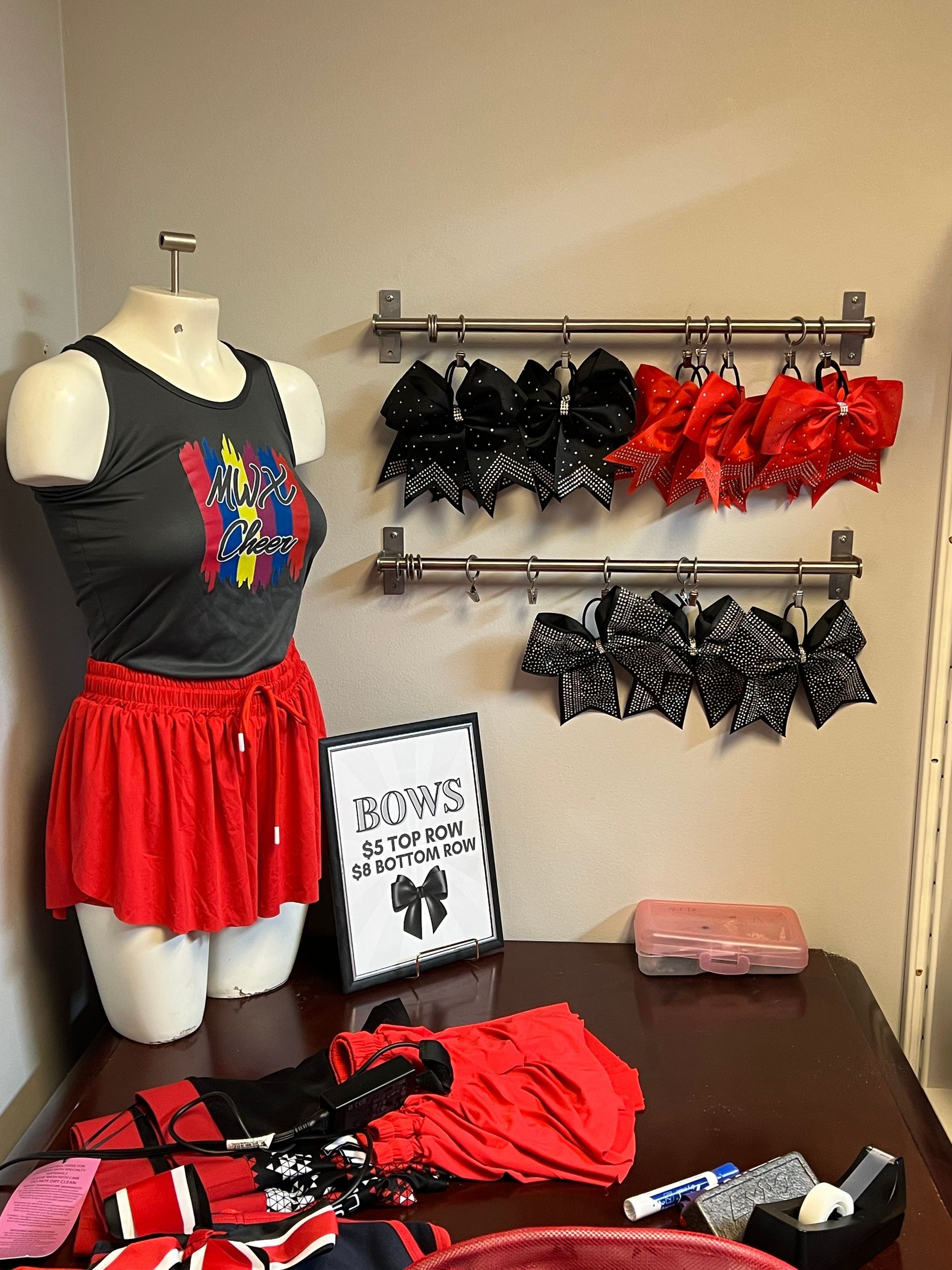 A mannequin is wearing a gray tank top and a red skirt