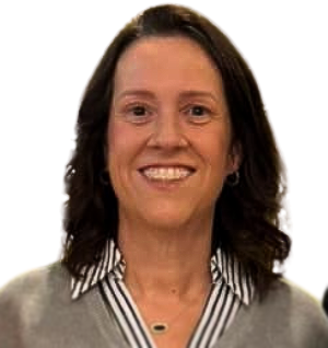 A woman wearing a striped shirt and a gray sweater is smiling for the camera.