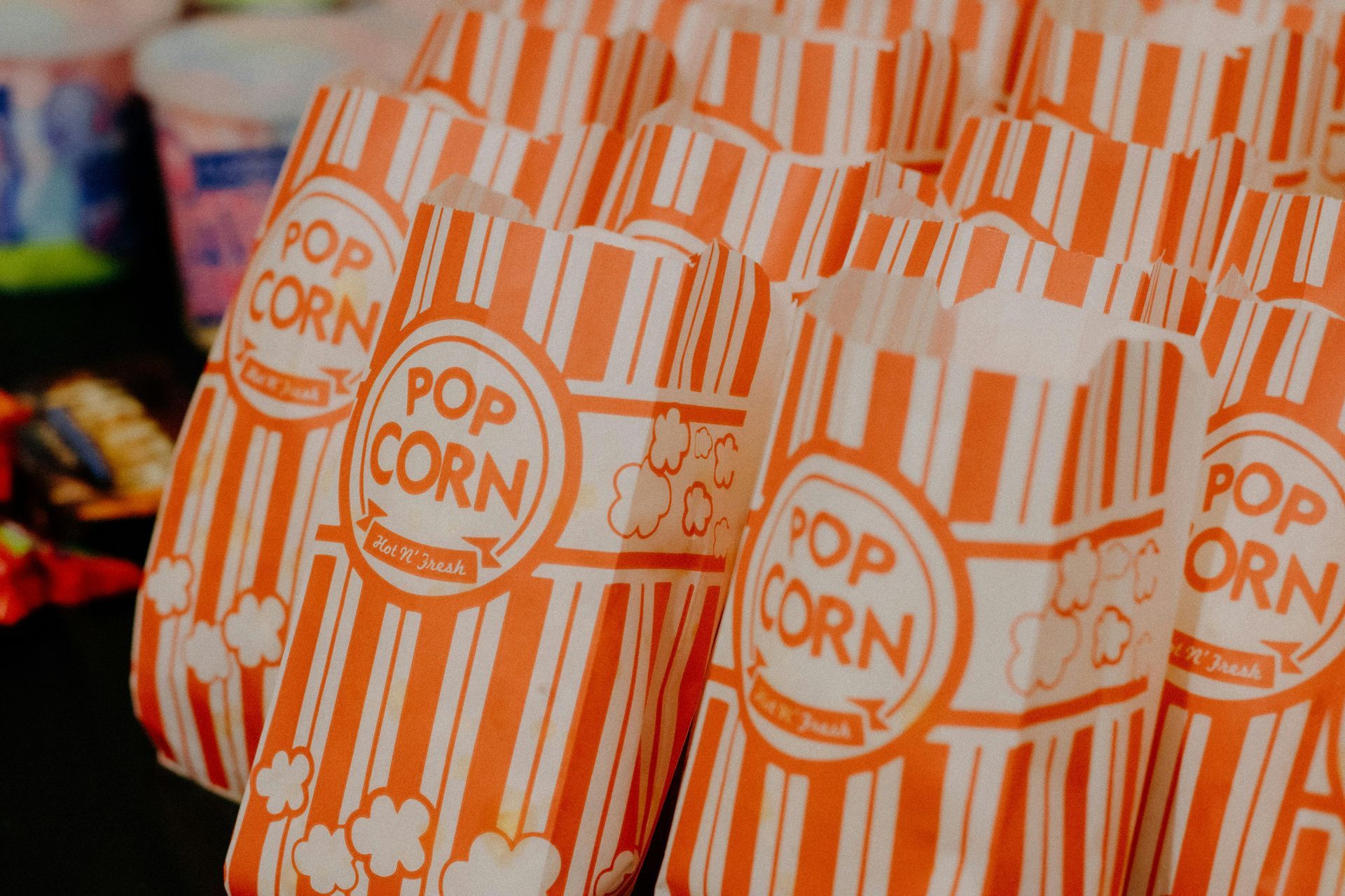 Stacks of popcorn bags, orange and white striped, with