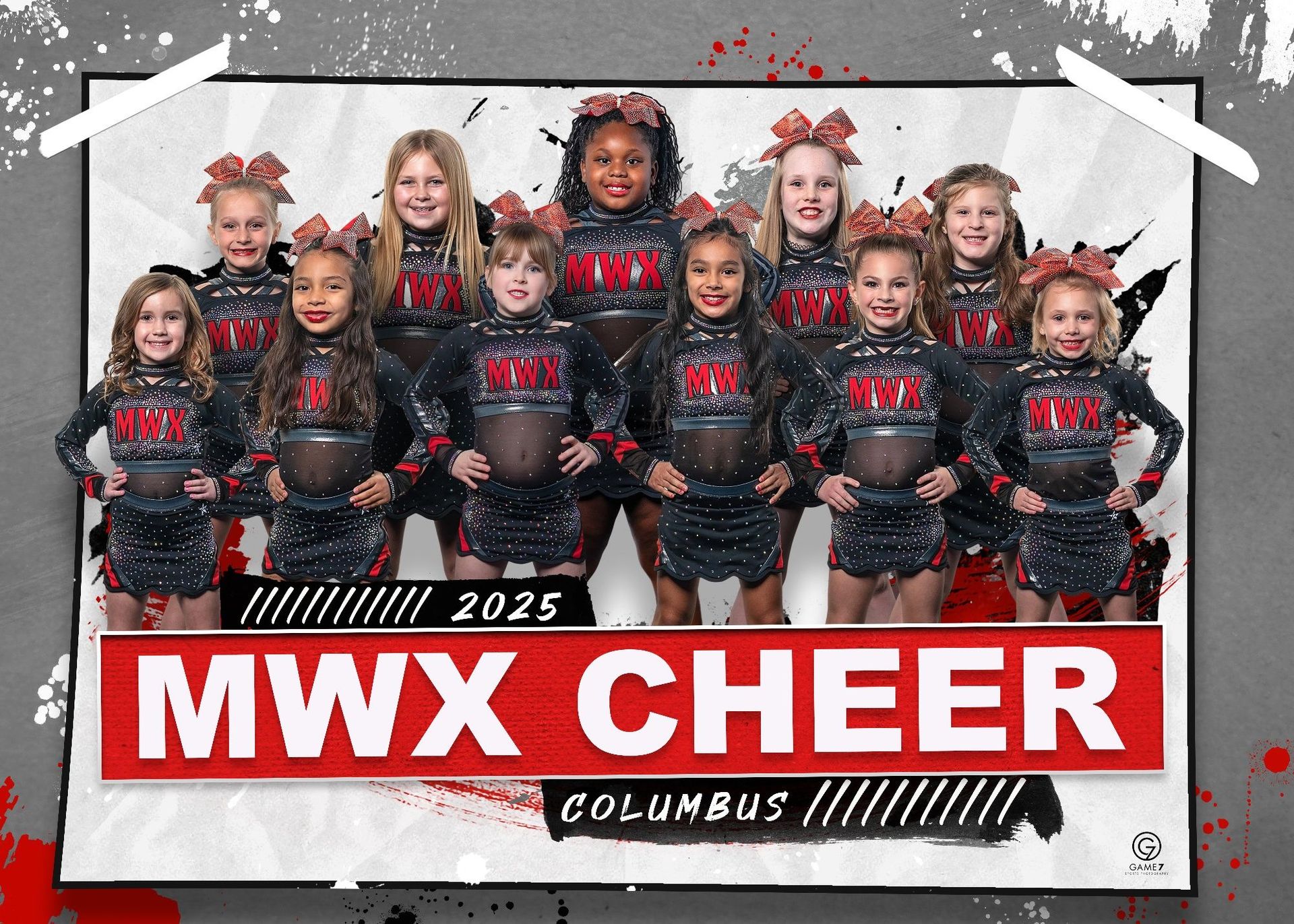 A group of cheerleaders are posing for a picture in front of a sign that says mwx cheer