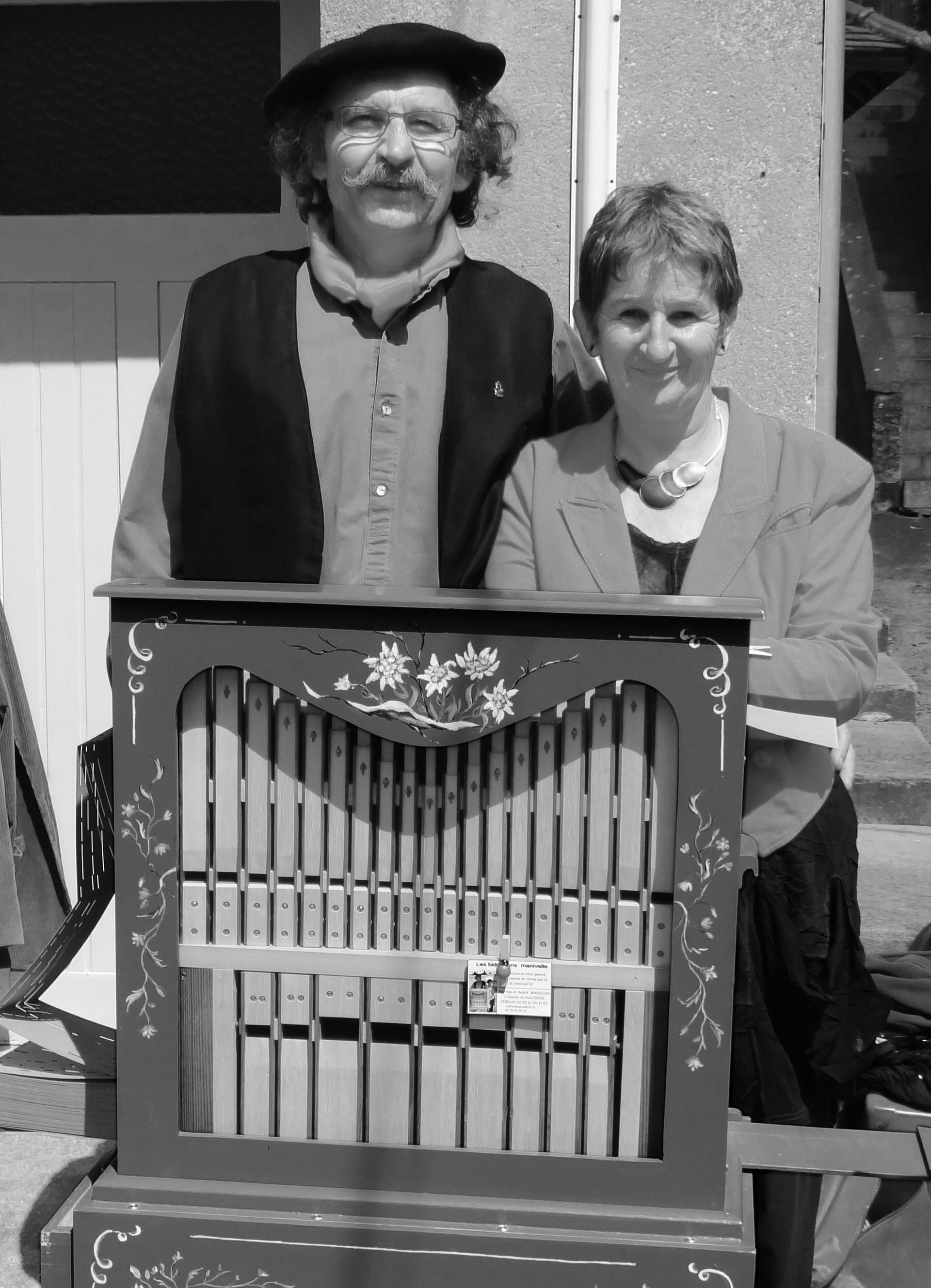 Een man en een vrouw staan ​​naast een orgel
