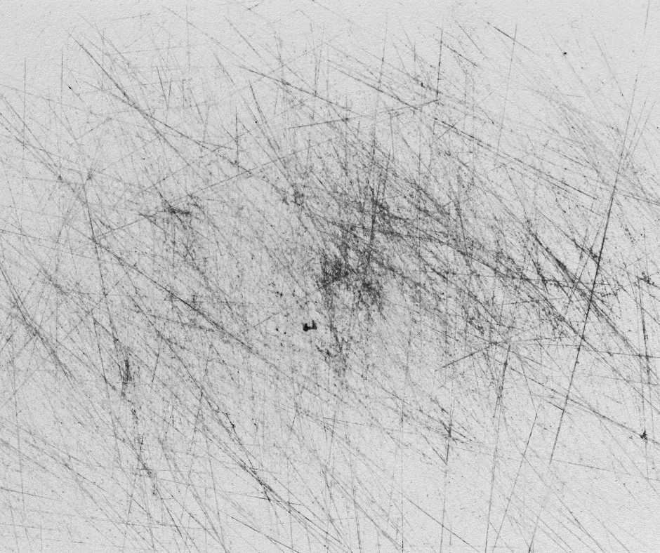 A black and white photo of a scratched surface