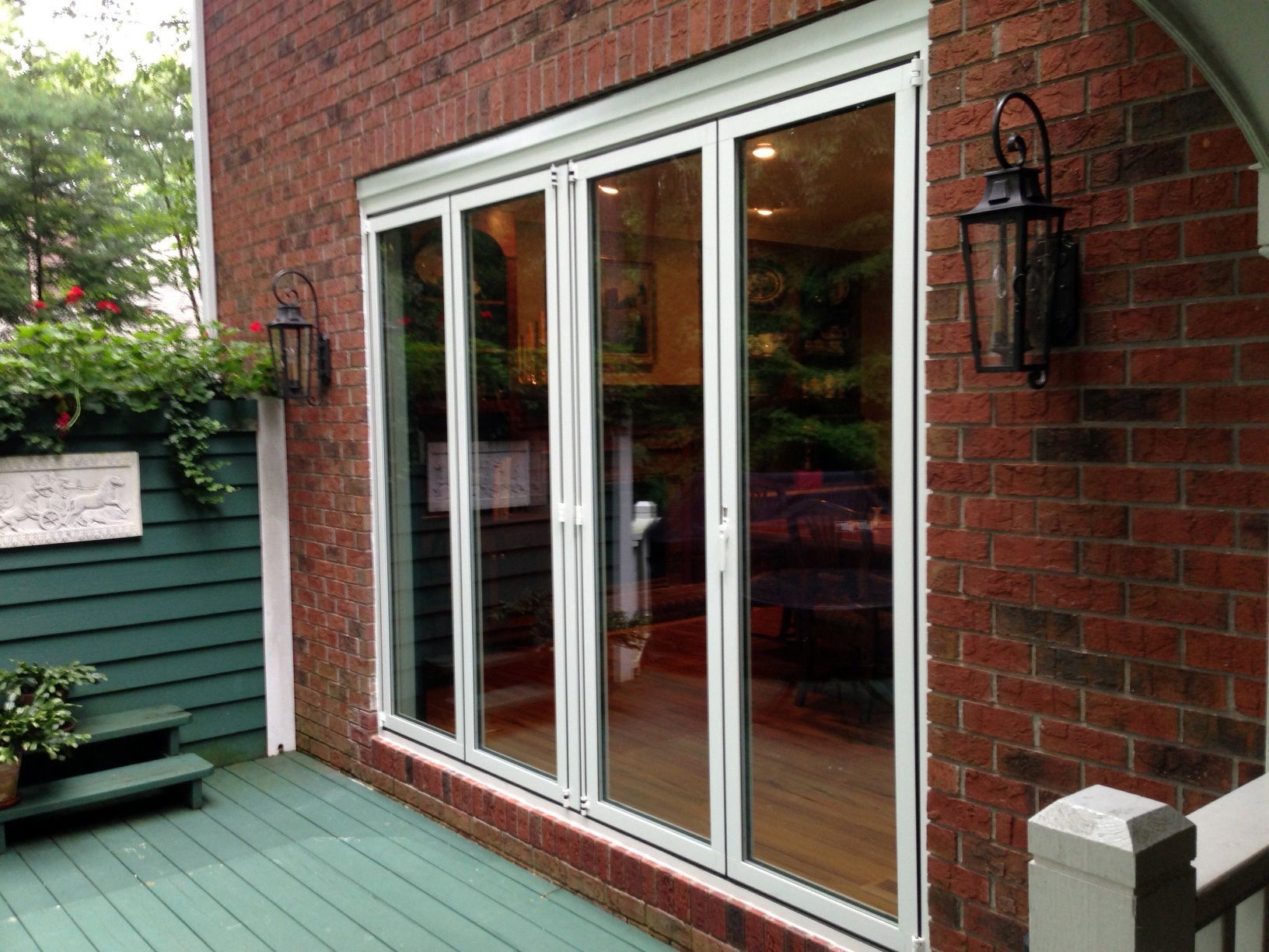 A brick building with a white sliding glass door