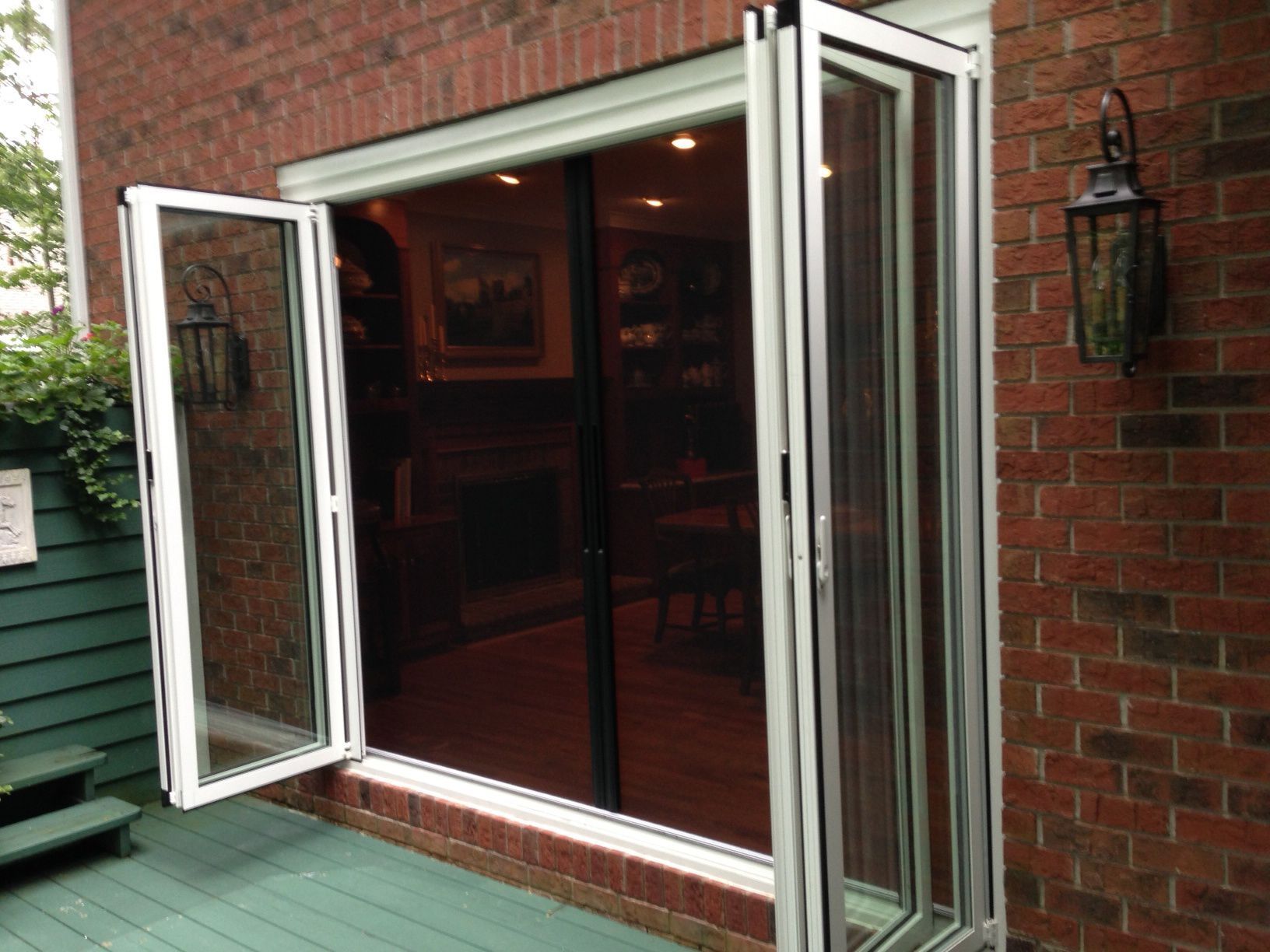 A brick building with a sliding glass door open