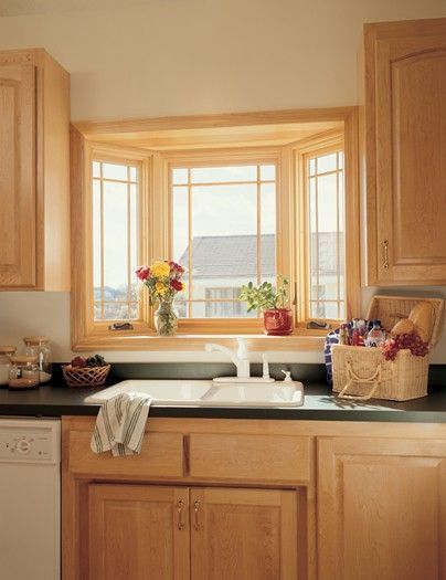 A kitchen with a sink and a bay window