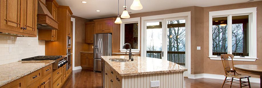 A kitchen with wooden cabinets and granite counter tops