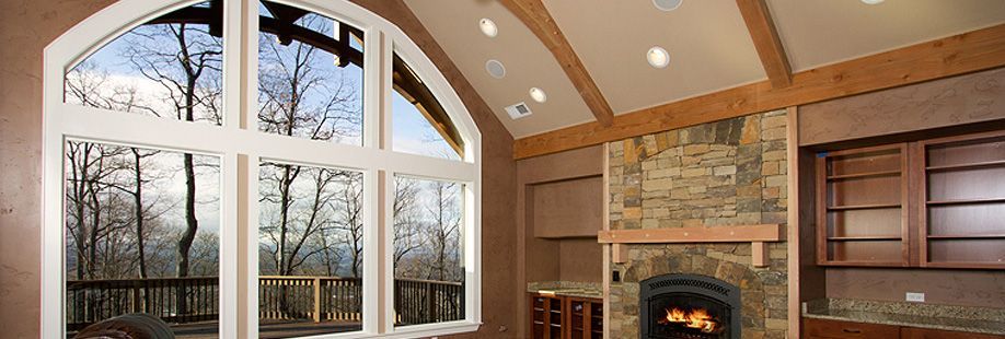 A living room with a fireplace and a large window
