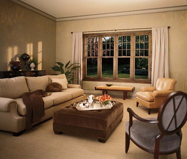 A living room with a couch ottoman and chairs