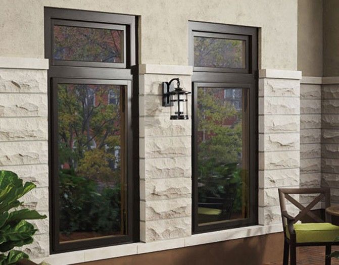 A patio with two windows and a lantern on the wall.