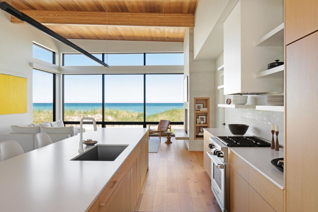A kitchen with a large island and a view of the ocean