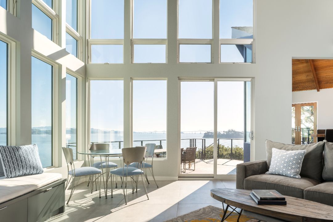 A living room with a lot of windows and a couch.