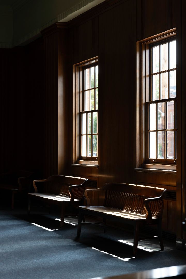 A dark room with two benches and two windows