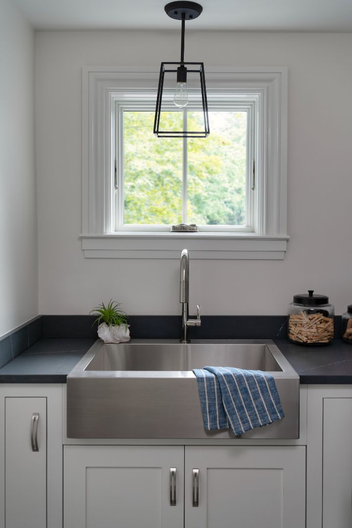 A kitchen with a stainless steel sink and a window.