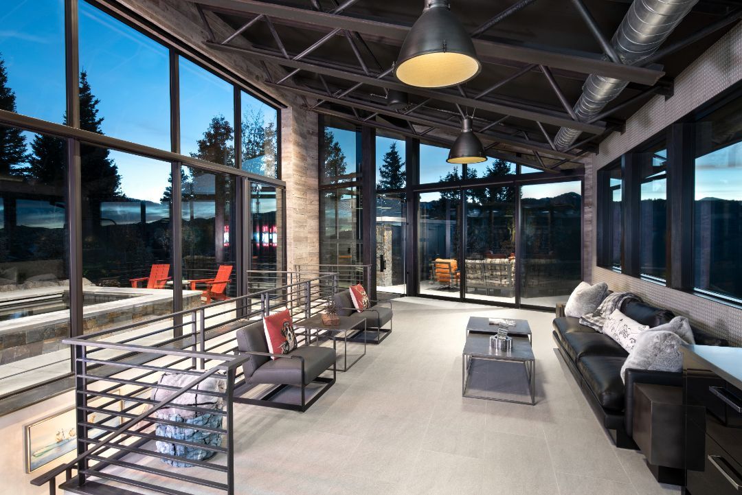 A living room with a lot of windows and furniture