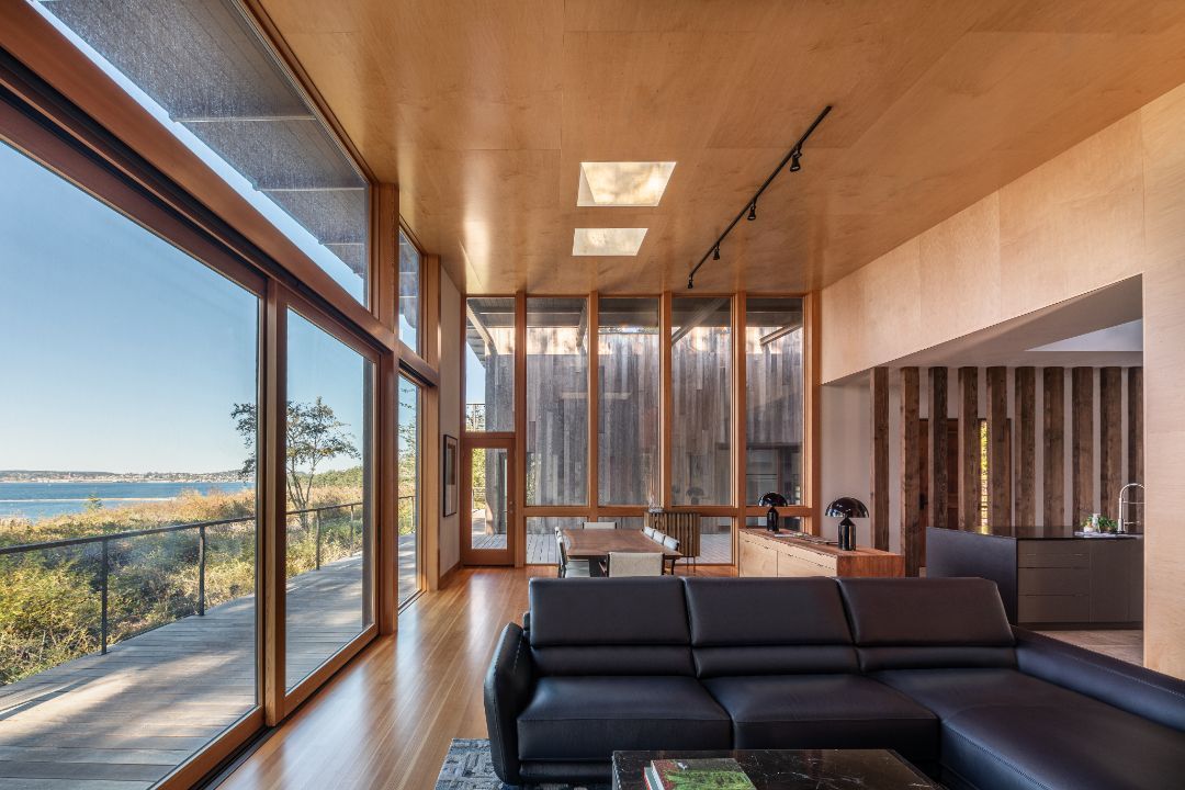 A living room with a couch and a lot of windows