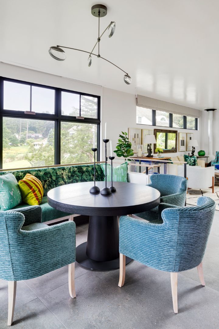 A living room with a table and chairs and a green couch