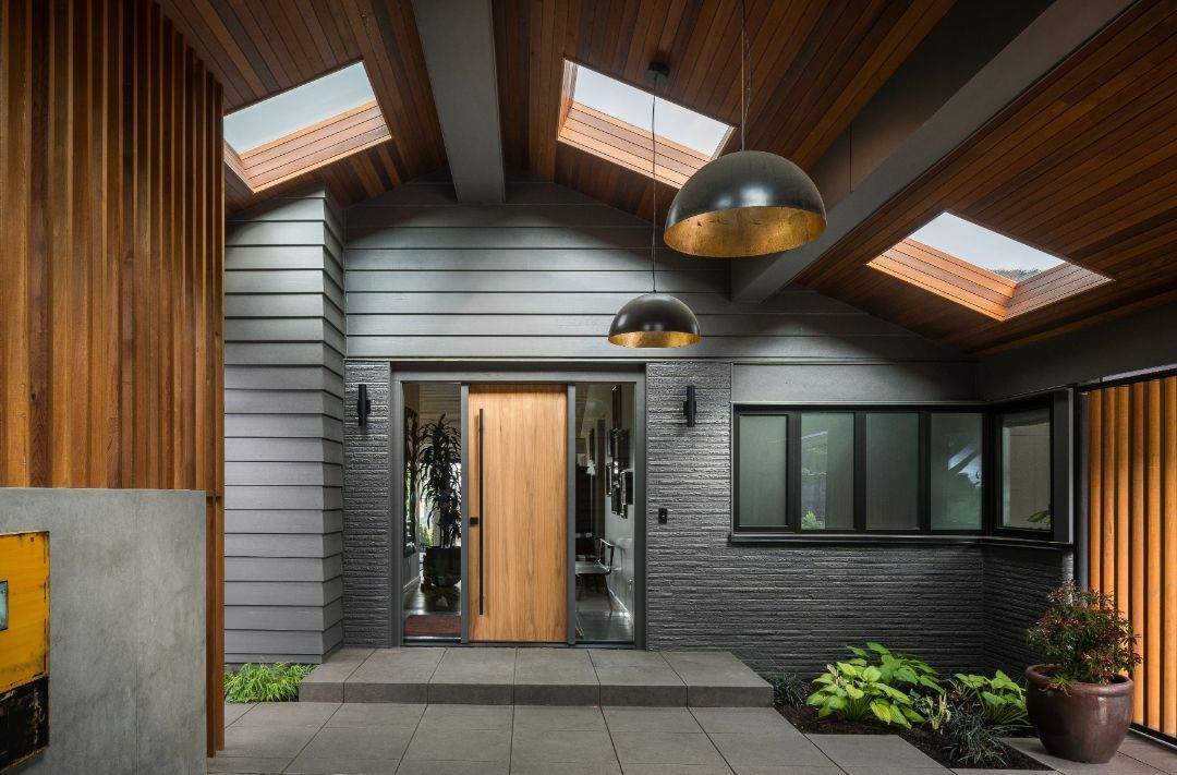 The front door of a house with a wooden door and skylights.