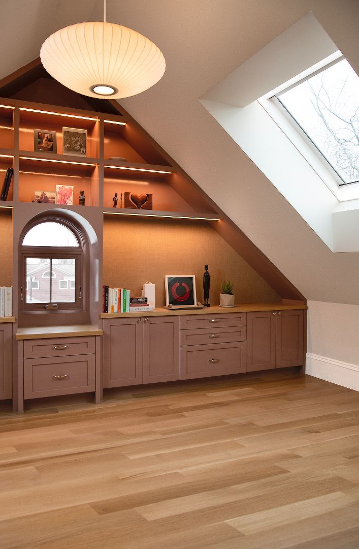 A room with a slanted ceiling and a window