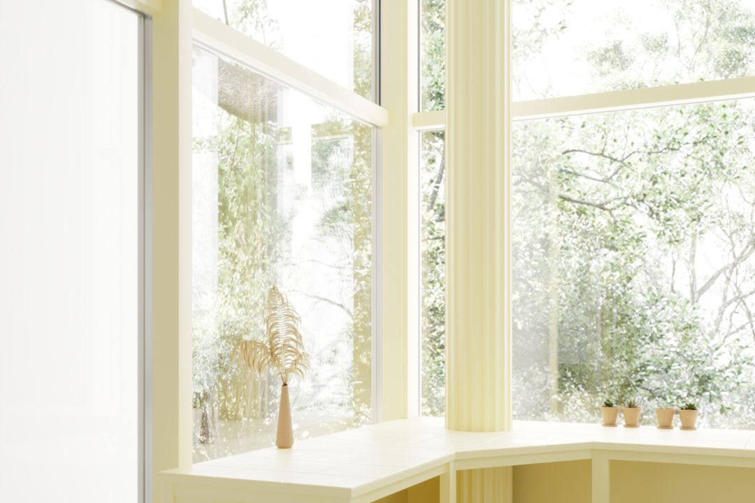 A room with a large window and a shelf with potted plants on it.