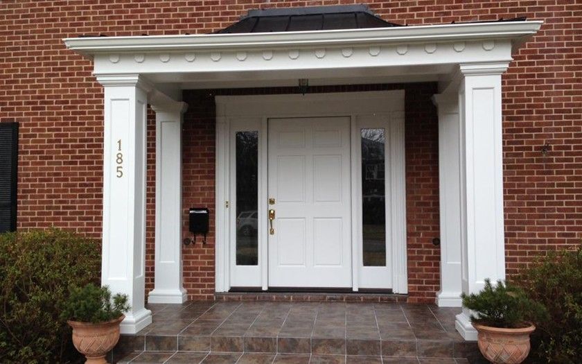 The front door of a brick building with a white door