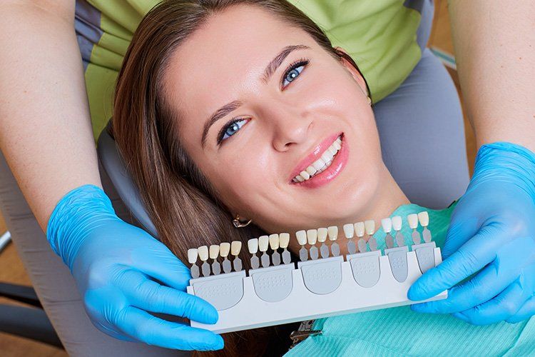 Woman Smiling next to dental veneers