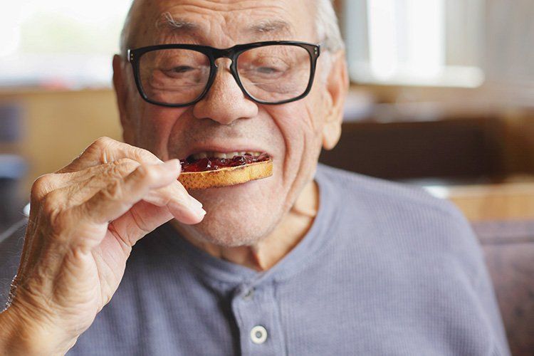 Older man eating toast