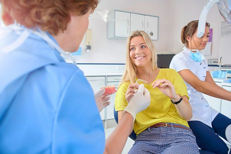 Young girl talking to dentist