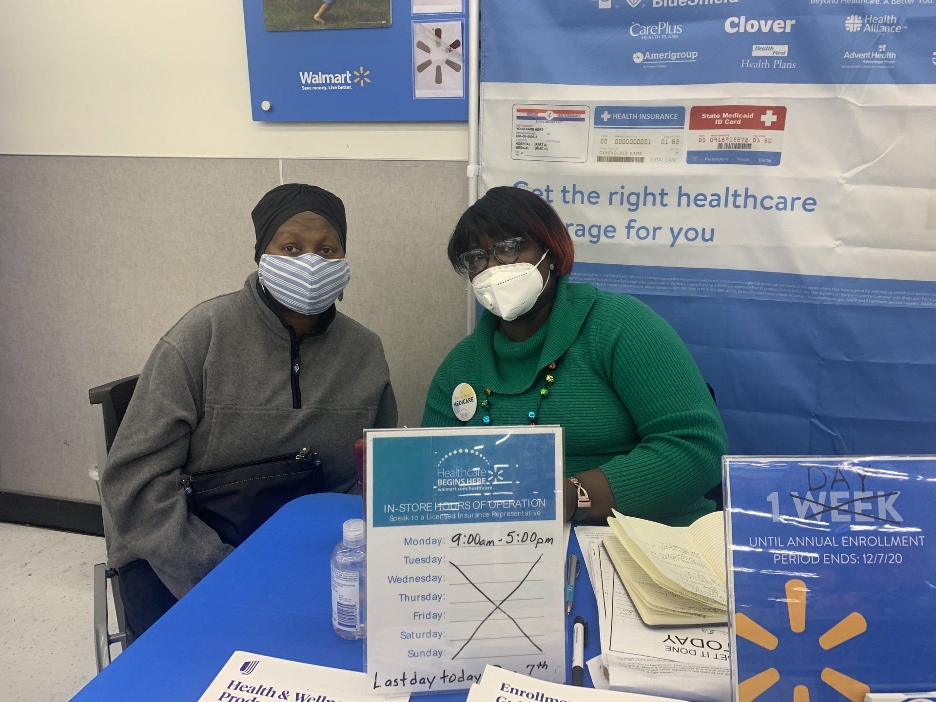 Front view of diverse senior couple using a digital tablet on sofa in beach house.
