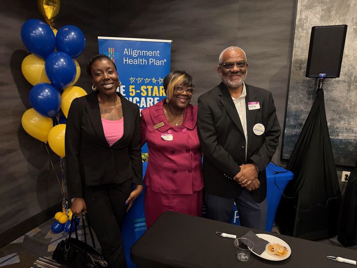 Front view of diverse senior couple using a digital tablet on sofa in beach house.