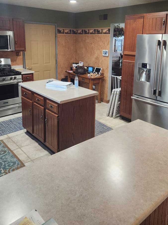 A kitchen with stainless steel appliances and wooden cabinets