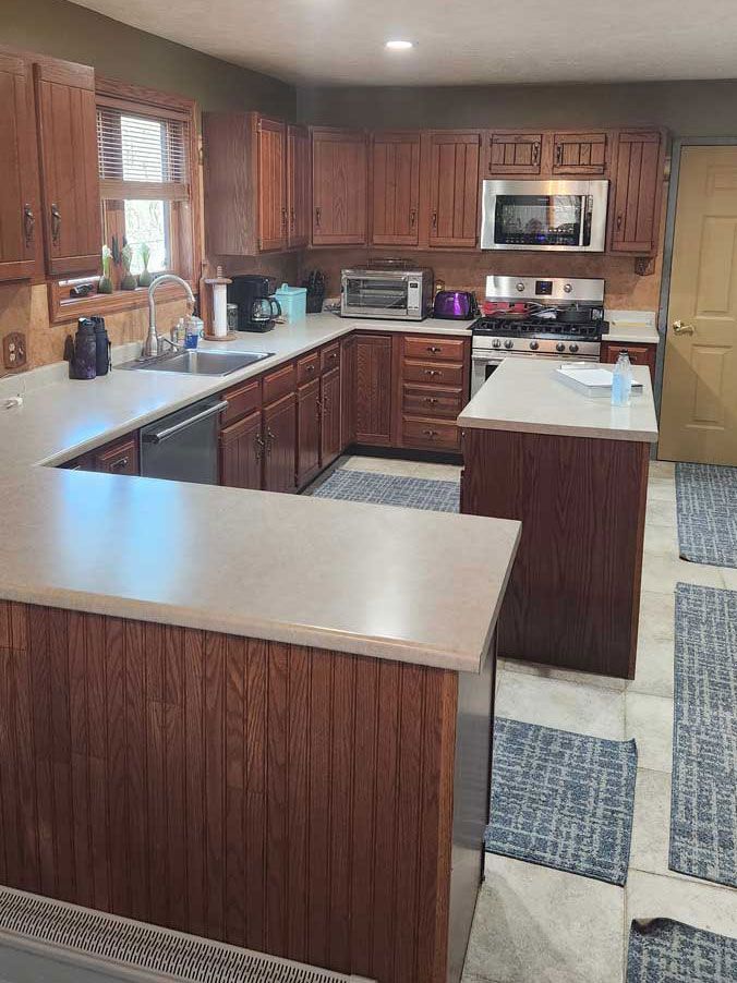 A kitchen with wooden cabinets and stainless steel appliances.