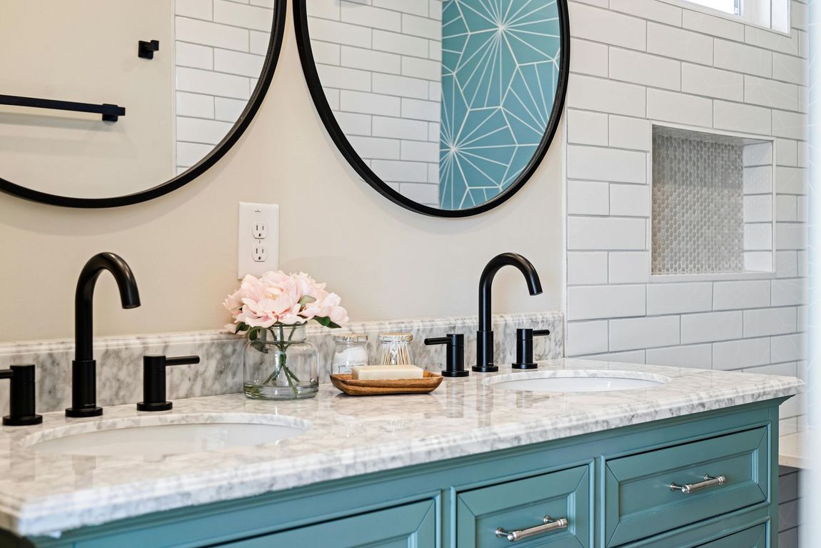 A bathroom with two sinks and two mirrors.