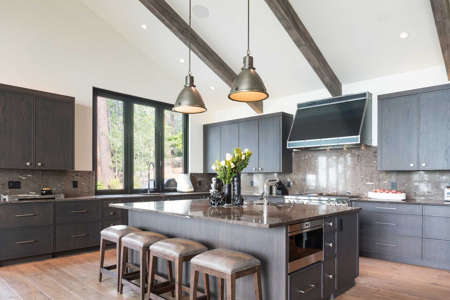 A kitchen with a large island and stools