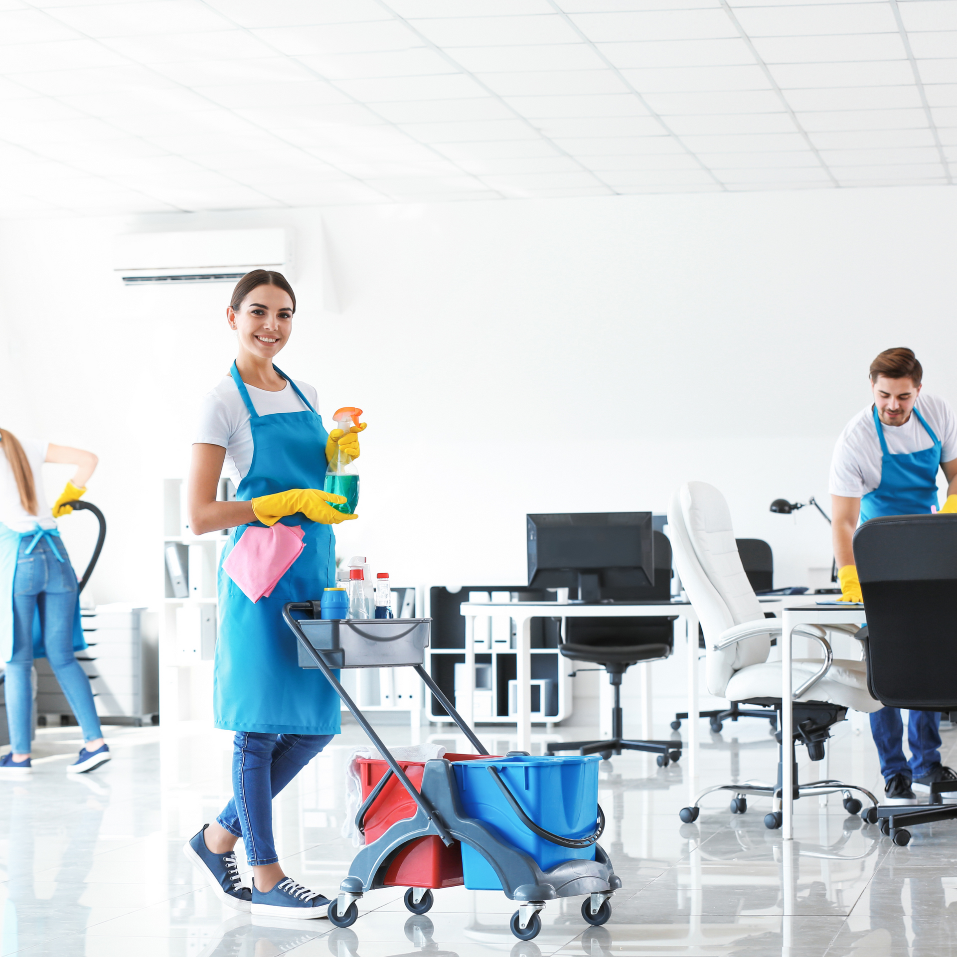 A group of people are cleaning a kitchen counter.