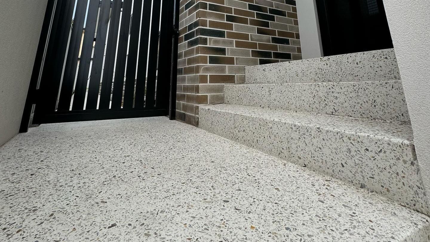 An exposed aggregate path and stairway with accent colours throughout the pour.