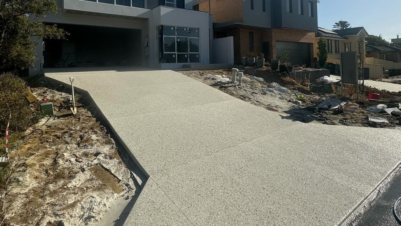 A large house with a driveway in front of it is being built.