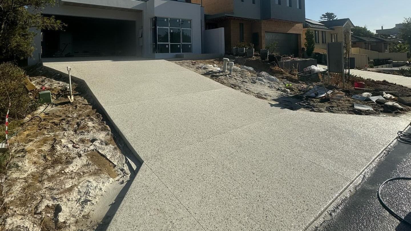 A driveway is being built in front of a house.