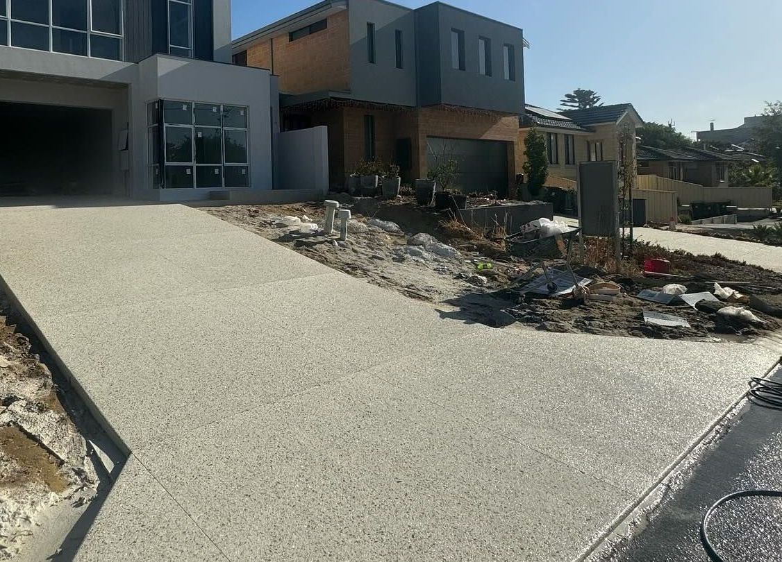 Amber white exposd aggregate driveway in new house build.