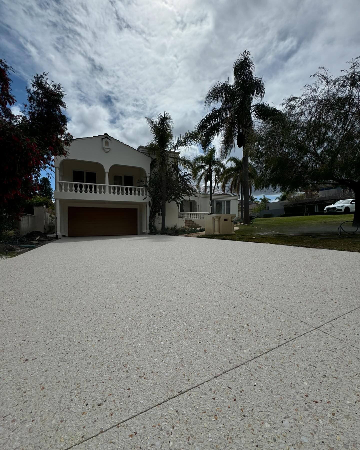 A new large exposed aggregate concrete driveway for two storey home in Perth.
