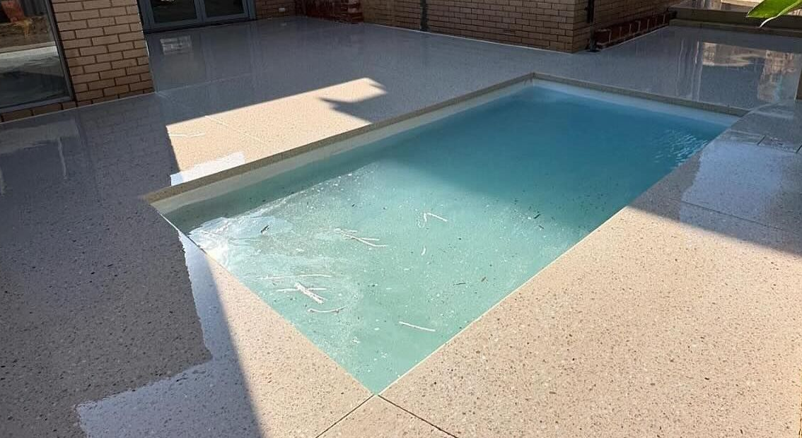 Coral White Honed concrete pool surrounds with speckled effect throughout.