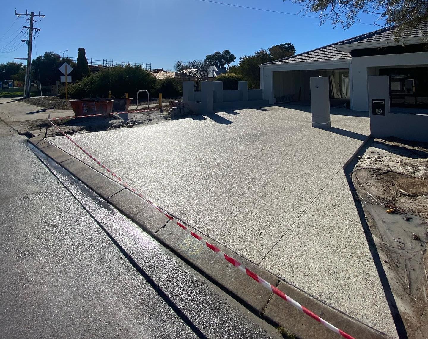 A concrete driveway is being built in front of a house