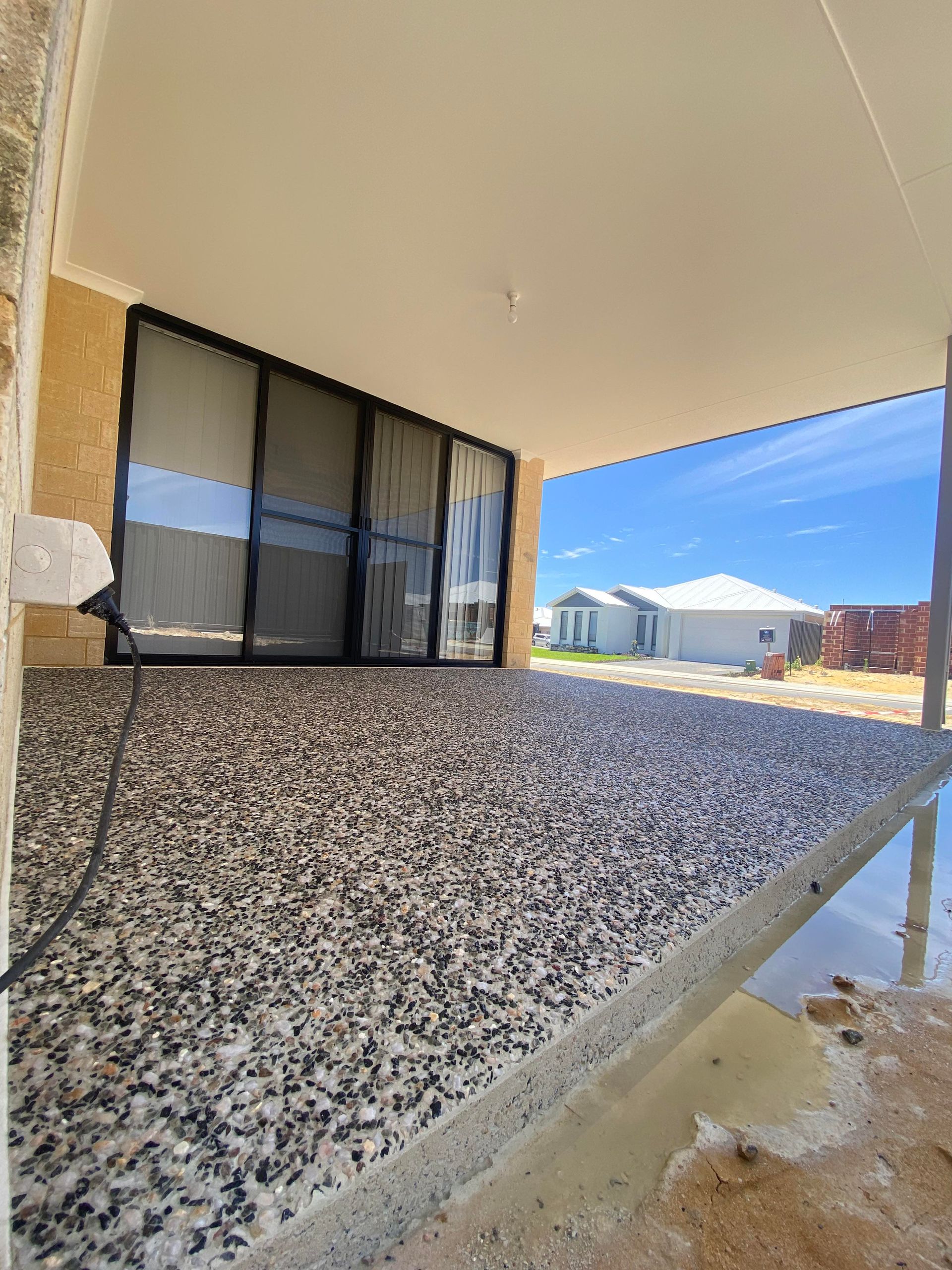 Salt and Pepper exposed aggregate mix for patio area in new Perth build.